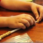 Stringing cheerios onto pipe cleaners