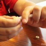 Stringing cheerios onto pipe cleaners