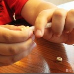 Stringing cheerios onto pipe cleaners